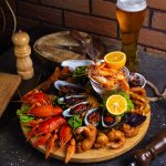 seafood plate with shrimps, mussels, lobsters served with lemon and glass of beer SSUCv3H4sIAAAAAAAACpyRz27DIAzG75P2DhHnRkqgY0lfpdrBIW6CSqECsmmq+u7jT6g474Z/tj/7M4/3t6YhEzgpyKl5xCjEUqnNeQteGh1wd9i5RT2jrQnO0hsrQdVwAi9WDTcMUG9KRfxMSeI8+M2hi8N2JMDjEjQyfEnkjc45bkoiJUNHSBFyqJjbpsQKyuL/6syPr+IGFtTiNy1cGbGoELKRcy4l1x+P9lZbg22WpnL1bQSoWMAqpbuVQuqlajN+TVcubcJs2tu4wmtzooy5w6TiiS9BEwtfwblQPhdeDRLhT82tmqONTwZ2VTKHn4hhzygdac86RnvKOaN8L8i/t8qgk9YpQiEWVznX1mXcgLDPaeBjT1sxcNYeGfIWOAztx3HscRj67sLGcPjnHwAAAP//AwANUblmhwIAAA==